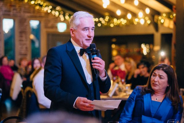 Father gives speech to room bride and groom