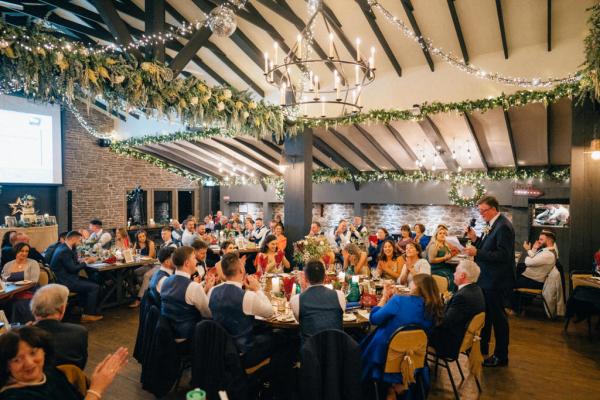 Room filled with guests family members during speeches