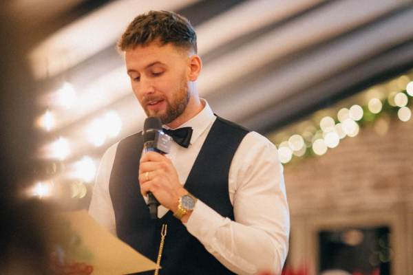 Groom or groomsman gives speech to guests