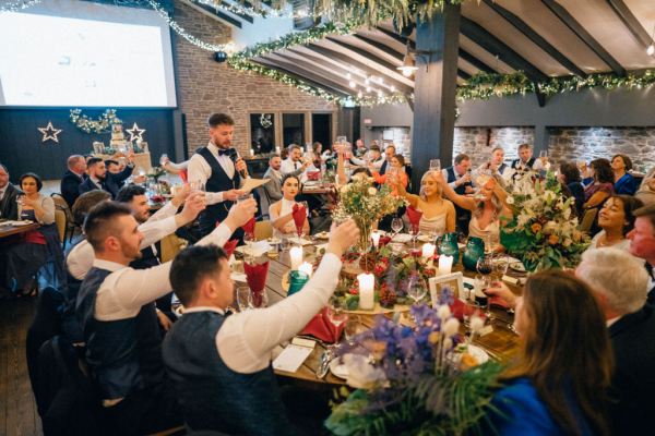 Guests cheers to groom giving speech