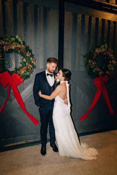 Bride and groom night time shot wreaths exterior on door