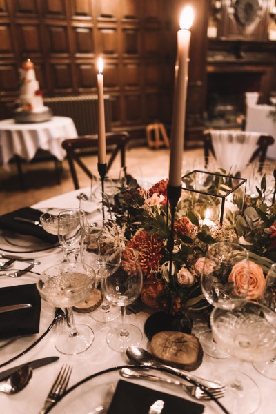 Flowers and candles places on table menus for guests