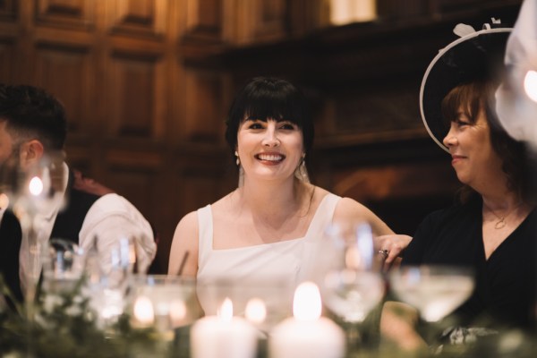 Candles in foreground bride in background smiling