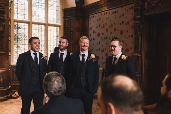 Groom and groomsmen stand at the alter waiting for bride