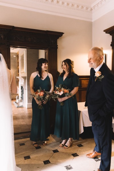 Father bridesmaids and bride enter ceremonial room