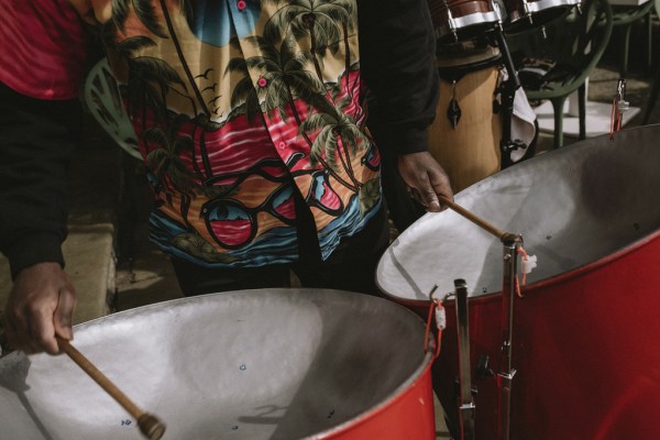 Colourful attire man playing drums musician