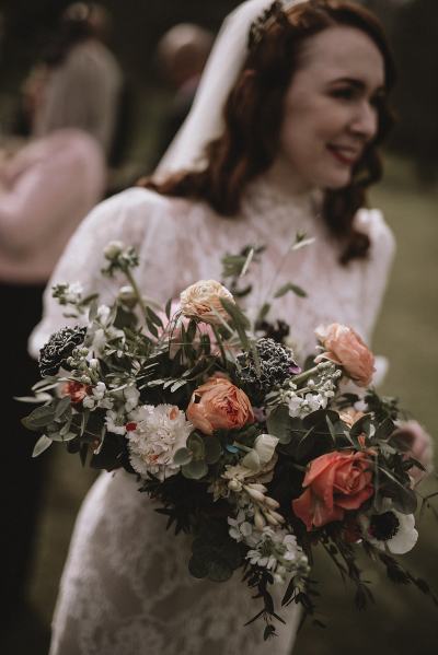 Bride holding bouquet close up of flowers/roses