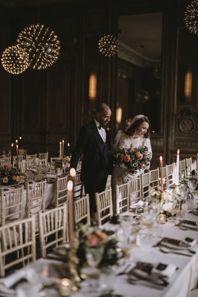 Bride and groom in the empty dining room ballroom setting table and chairs