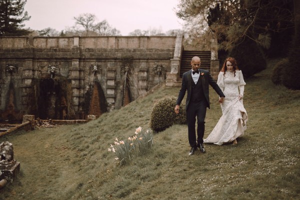 Bride and groom walking along the grass forest park setting