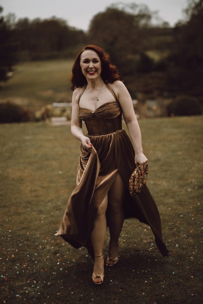 Bridesmaid in brown velvet dress on grass