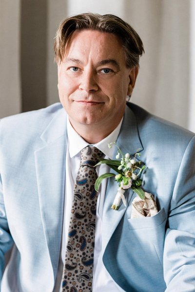 Close up of groom in blue suit