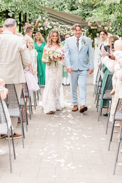 Bride and groom exit ceremony guests clap confetti on floor