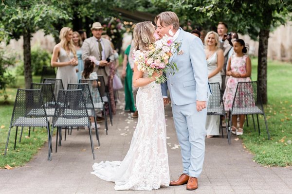 Bride and groom during ceremony they kiss in front of guests