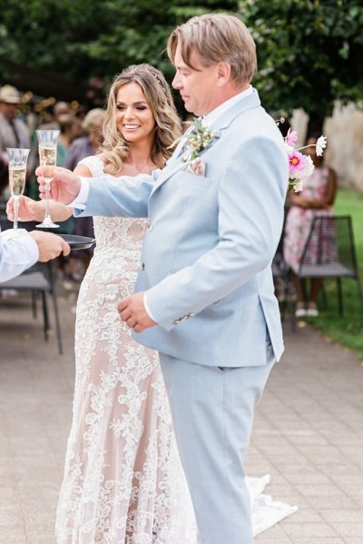 Bride and groom cheers with prosecco or champagne