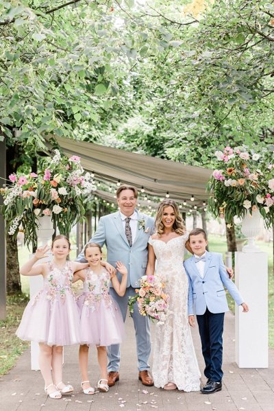 Bride groom little girls and boy outside family portrait