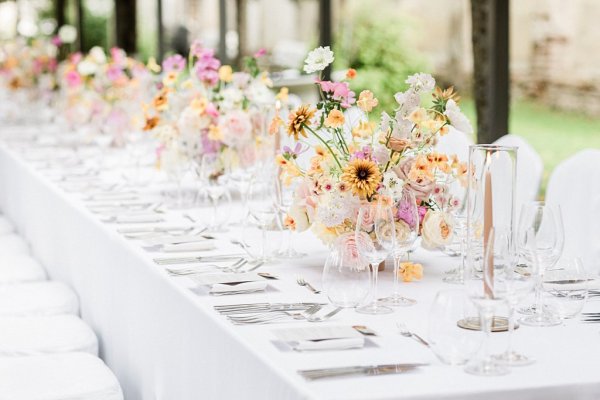 Colourful bouquet flowers table wine glasses cutlery