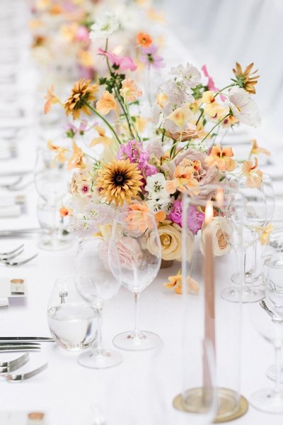 Colourful bouquet flowers table wine glasses