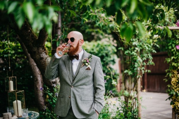 Groom drinking pint of beer