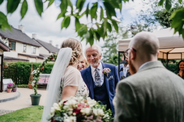 Father bride and groom at alter