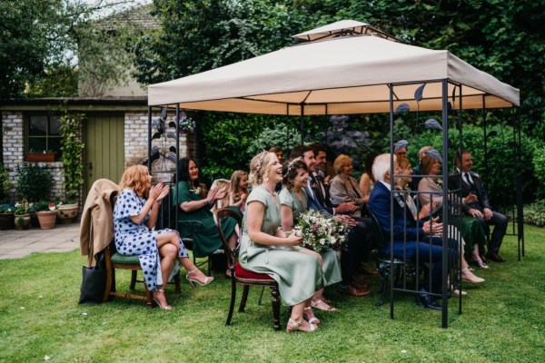 Guests seated during ceremony under tent