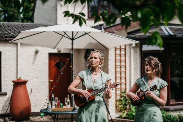 Bridesmaid or singer sings and plays guitar wedding singer band