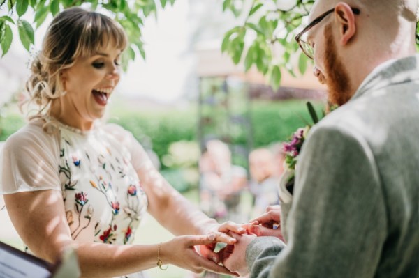 Bride happy smiles laughing holding grooms hands