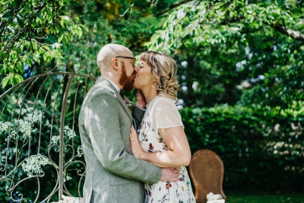 Bride and groom kissing kiss in the garden