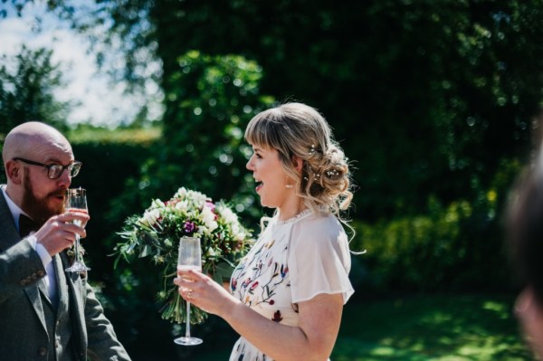 Bride holding glass of champagne smiling