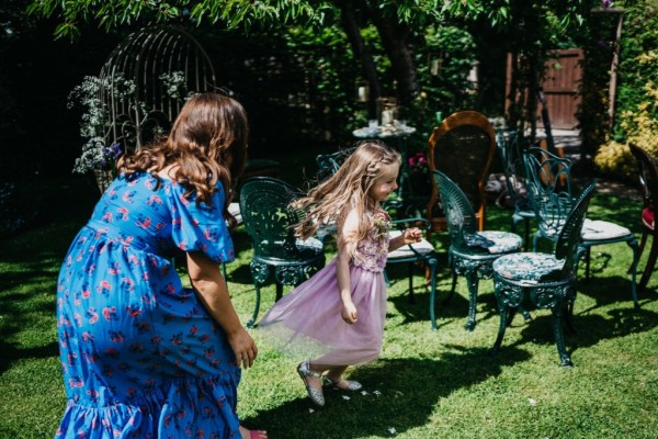 Little girl playing in the sun with mother/woman