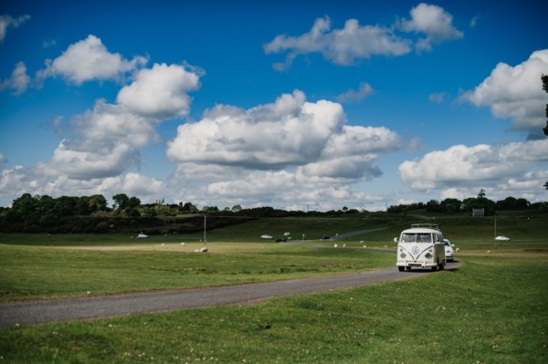 Grass shot white wedding car blue skyline