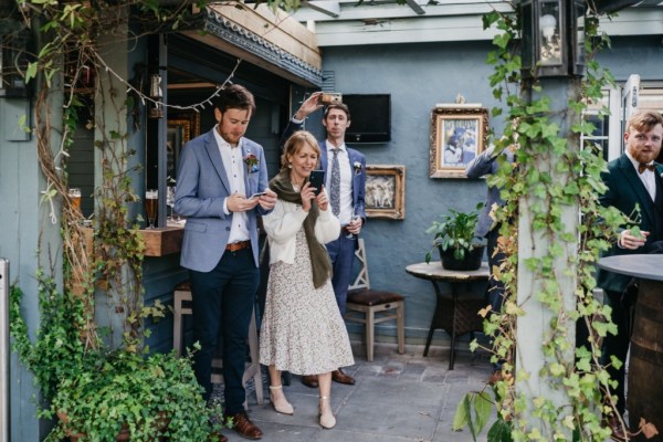 Guests taking pictures of the happy couple