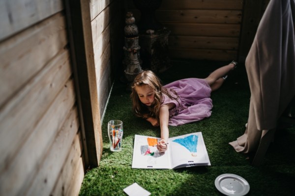 Grass and little girl playing and drawing