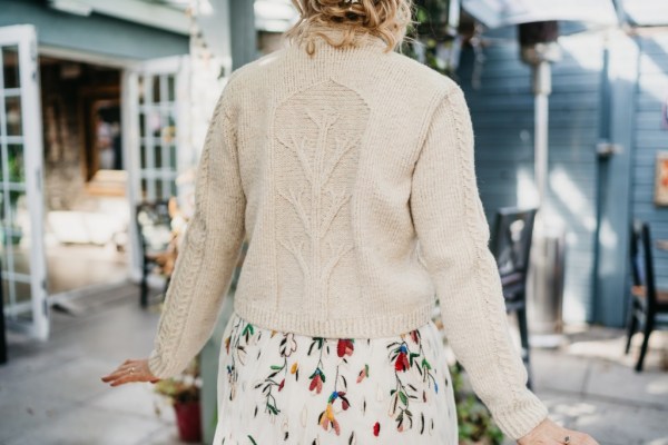 Bride wears cardigan over floral dress