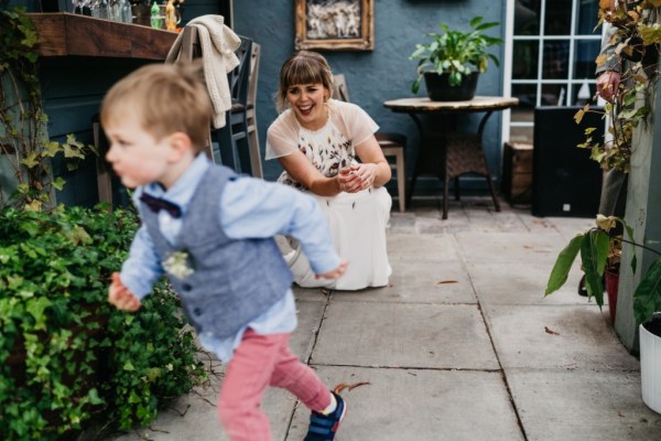 Bride and little boy playing outside