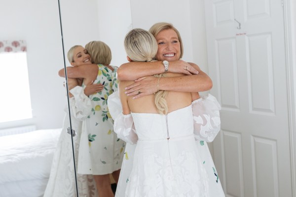 Mother hugs daughter bride