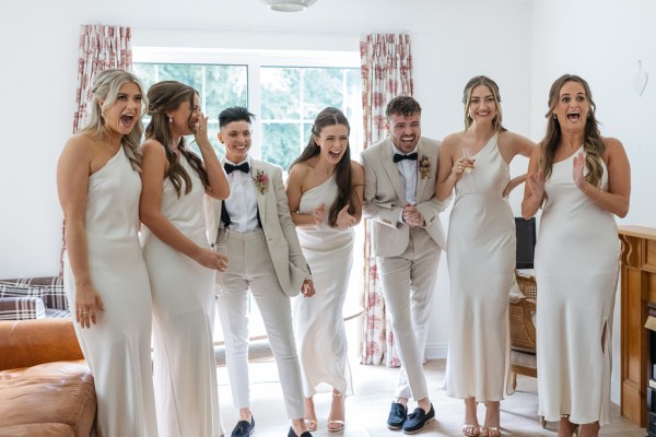 Bride groom and bridesmaids celebrate smile laugh