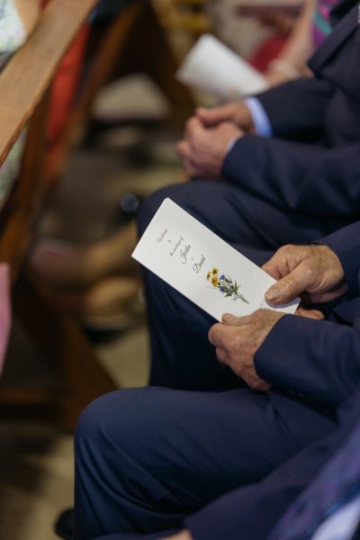 Man holding wedding catalogue booklet card