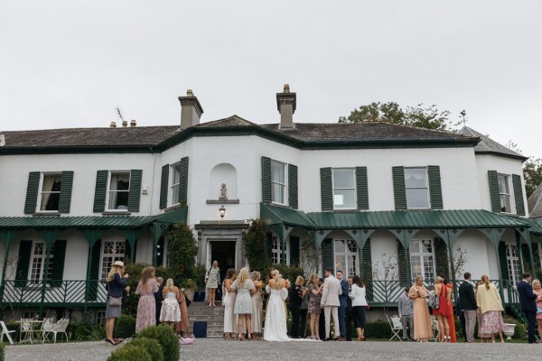 Exterior guests atmosphere shot outside of wedding venue