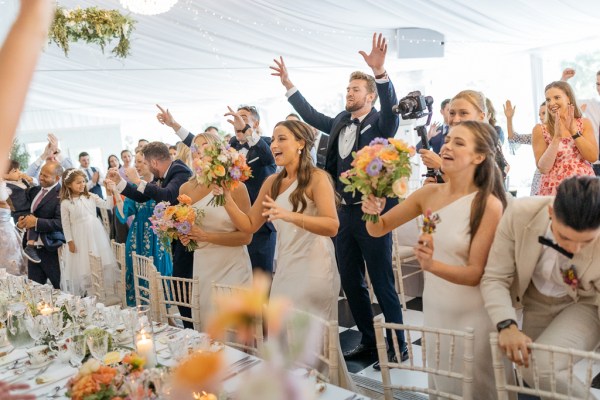 Guests clapping cheers celebrating welcoming couple