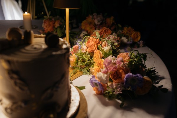 Bouquet colourful flowers on table with cake