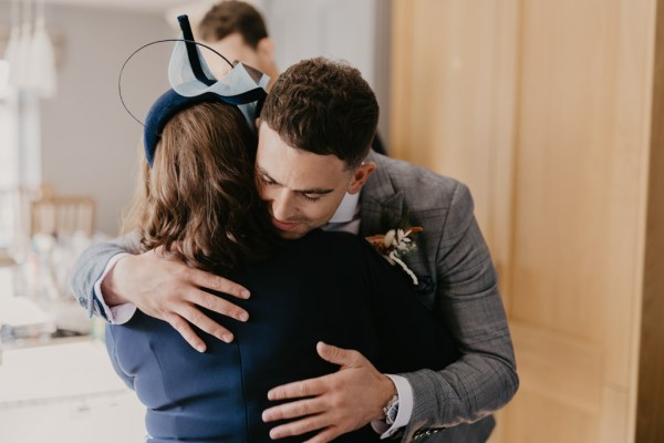 Groom hugs mother