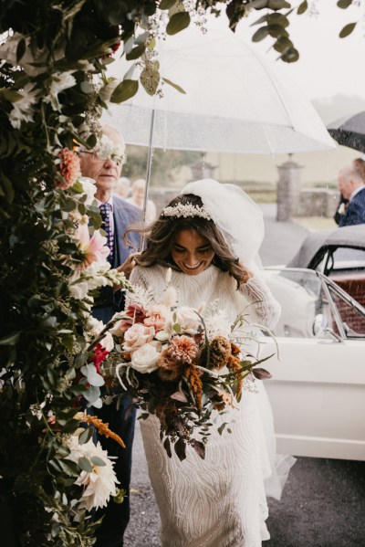 Bride walks into church holding roses flowers bouquet