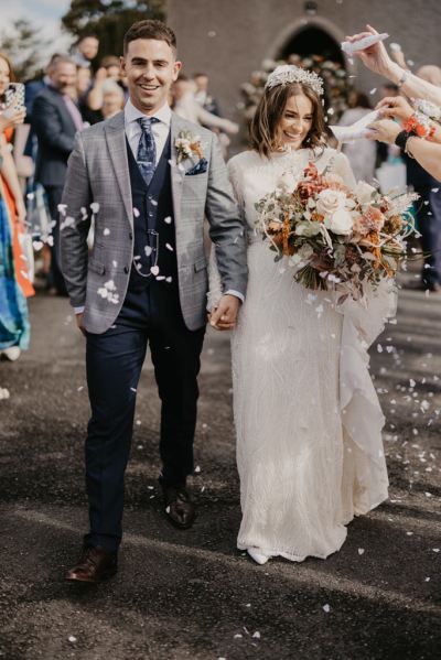 Confetti is thrown over bride and groom