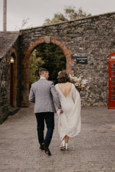 Bride and groom walking towards wedding venue