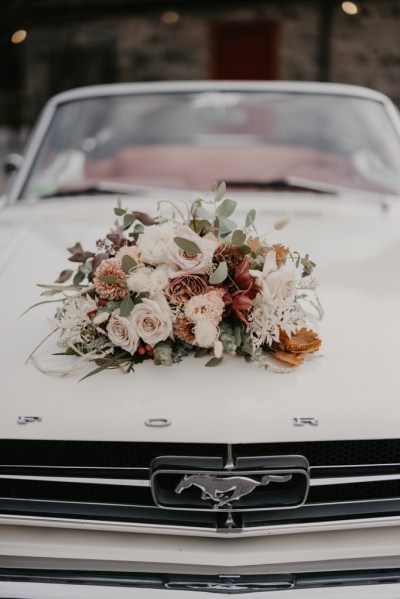 Close up of pink red roses flowers on wedding car bonnet