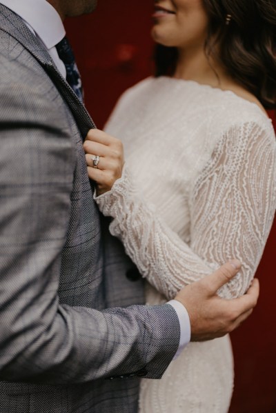 Groom cupping elbow of bride