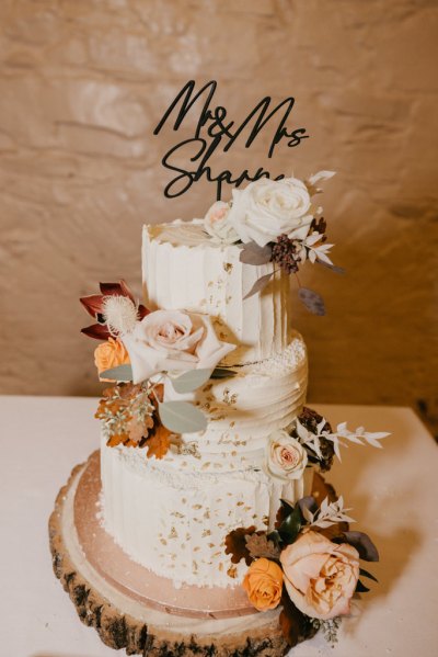 Wedding cake covered in pink roses flowers