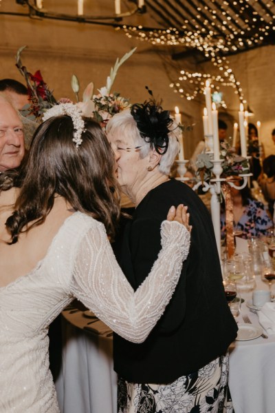 Bride kisses mother on the cheek