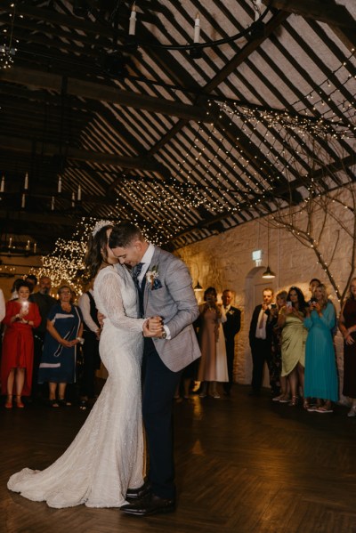 Bride and groom dance slowly on the dancefloor