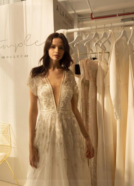 An Ode to Sophia: Bo & Luca Collection bride trying on bridal dresses look